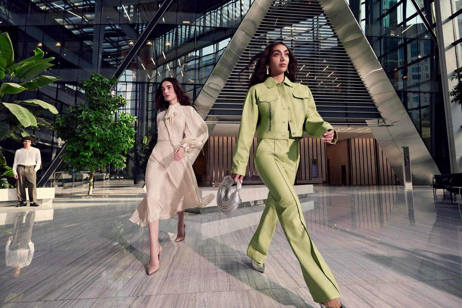 Two women walking through the marble-floored atrium at ICD Brookfield Place